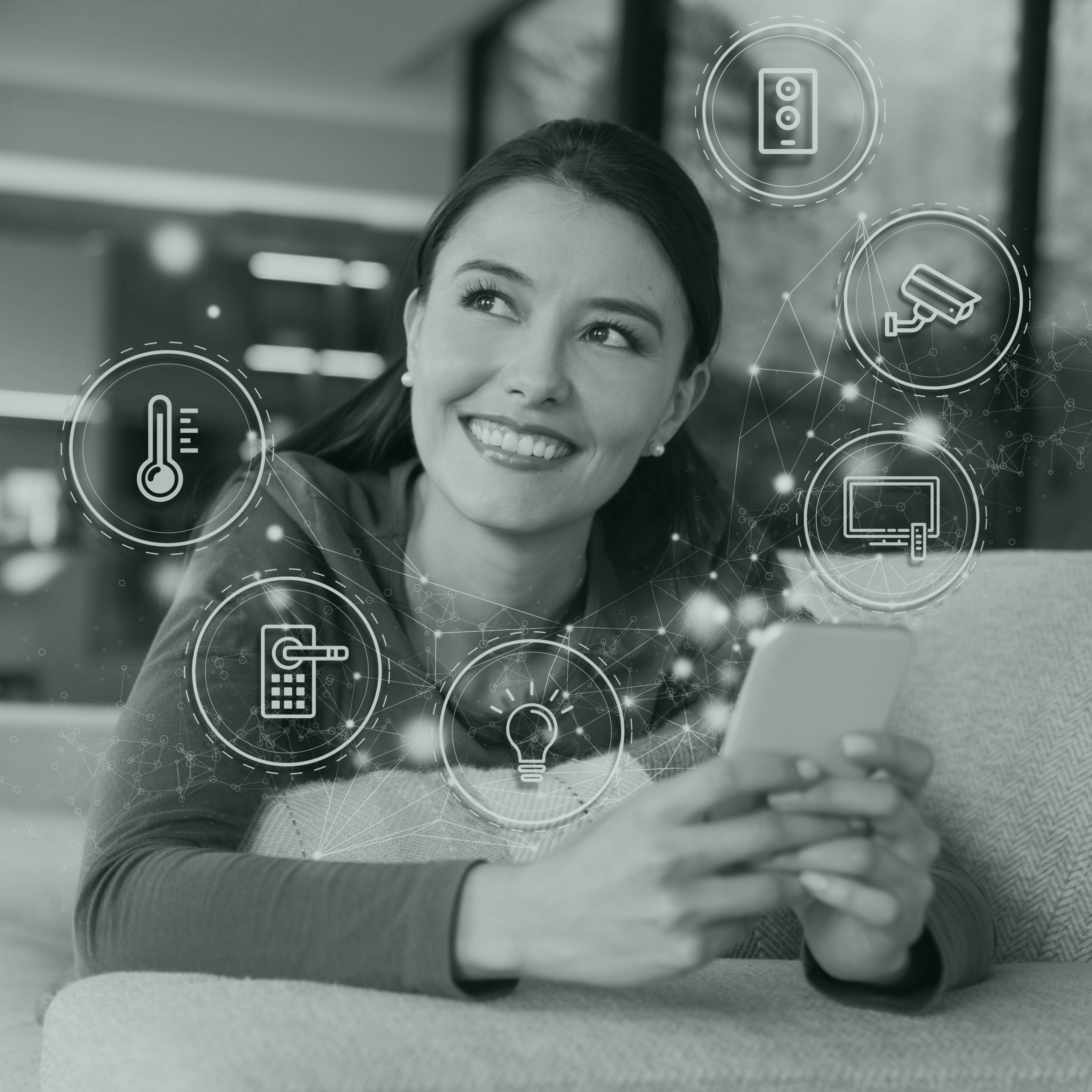 Smiling young woman holding a telephone from which several illustrations of connected objects (camera, television, light bulb...) emerge